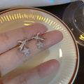 Pair of Metal Tone Star and Bow Drop Earrings with Crystal Accents view 2