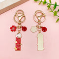 Cat Charm Keychains Featuring Red Blossom Across 17 Pictured Variations view 8