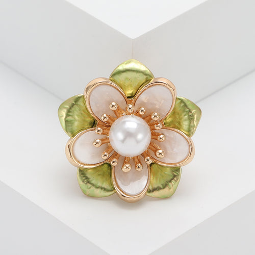 Alternate finish view of layered translucent camellia petals surrounding a pearl center