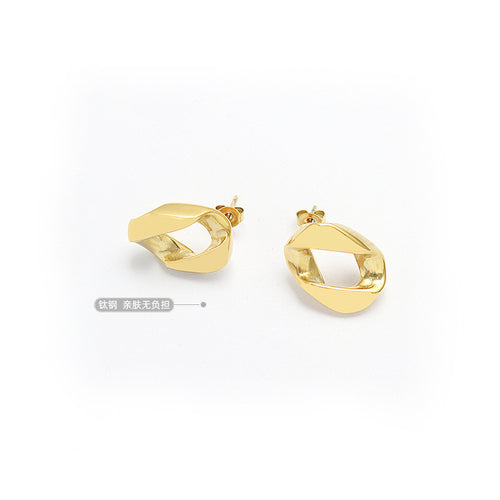 Pair of gold twisted hollow square studs angled on white with label