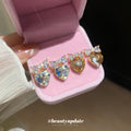 Gold Tone Crystal Heart Stud Earrings with Bow Details view 2