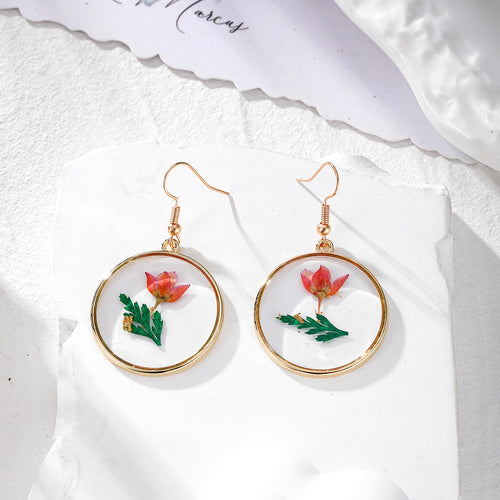 Single red pressed flower gold circle earrings with green leaves