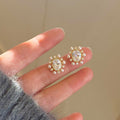Gold Tone Floral Stud Earrings with White Pearl Clusters view 1