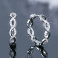Crystal Set Wavy Hoop Earrings in Silver and Gold Tones view 1