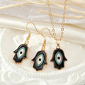Gold Tone Black Enamel Hamsa Eye Necklace and Hook Earrings view 1