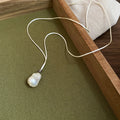 Silver Flower Pendant And Baroque Pearl Cord Necklaces view 7