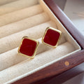 Gold Tone Square Stud Earrings with Deep Red Centers view 1