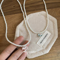 White Beaded Necklace with Blue Enamel Rocking Horse Pendant view 2