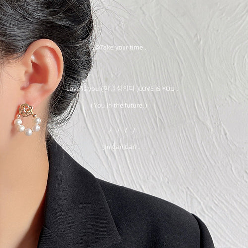 Model wearing gold rose freshwater pearl open loop earring
