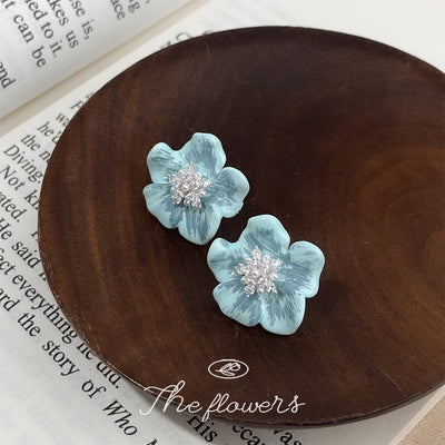 Aqua-blue flower clear-stone cluster studs in the first product display.