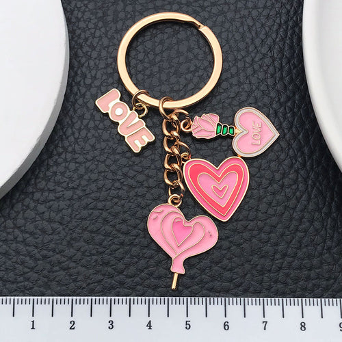 Alternate arrangement of the pink love heart rose and potion metal keychain showing its hardware and charm details