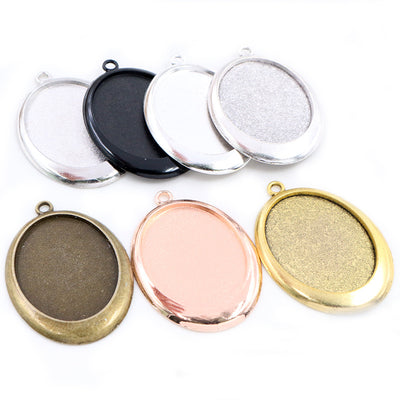 Image 1 showing oval pendant bezel settings in five dark and metallic finishes in the pictured colors and forms