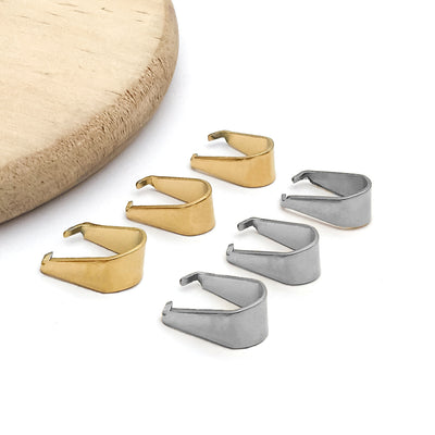 Gold-tone connector clasp jewelry findings arranged on a light background