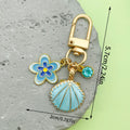 Starfish, Conch and Shell Charm Keychains Featuring Navy Flower Across 64 Variations view 4