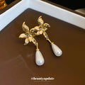Gold Tone Bow And White Teardrop Pearl Drop Earrings view 2