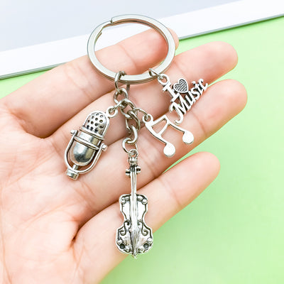 Image 1 showing a hand holding two keys and a microphone.