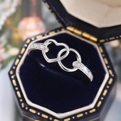 Front product view of silver tone double open heart ring with clear stone shoulders