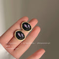 Matte Gold Black Enamel Oval Stud Earrings Purple Floral Motif view 1