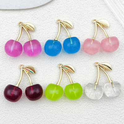 Multicolor cherry charms arranged on a light background