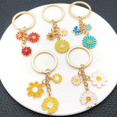 Overview showing the available color and design variations of the colorful daisy flower metal keychain design