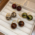 Gold Tone Hoop And Stud Earrings With Marbled Resin Ball Drops view 1