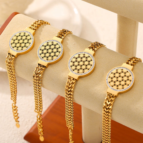Four gold Cuban chain cutout disc bracelets on beige display
