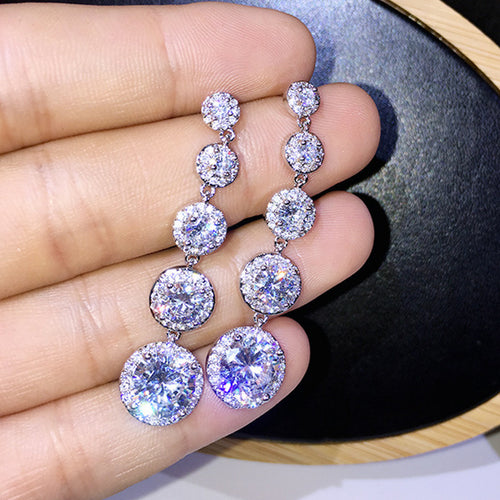 Graduated Round Clear Stone Drop Earrings Metal Jewelry Design shown in a front close-up