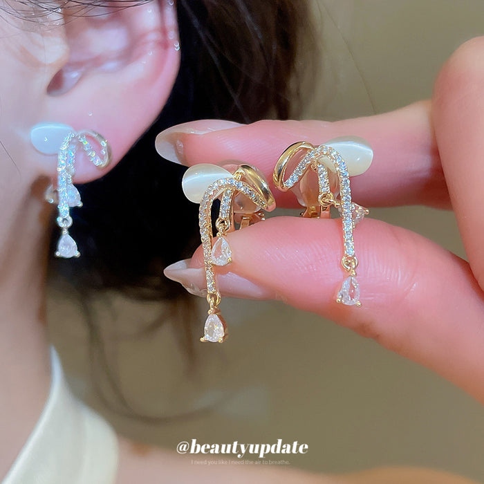 Crystal Bow Short Dangle Clip On Earrings With Polished Metal Details