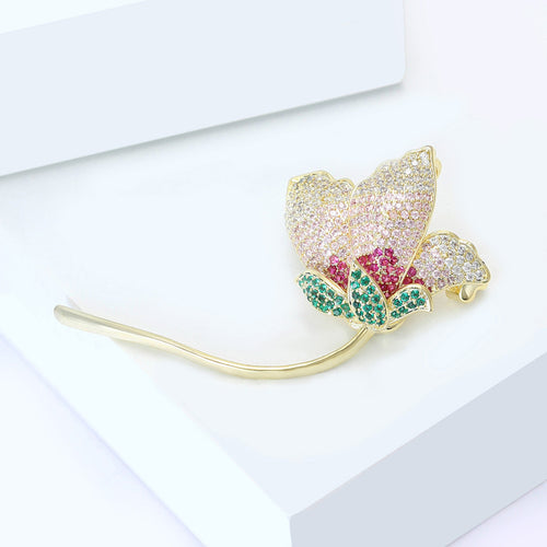 Angled view pink white magenta rhinestone flower brooch on white block