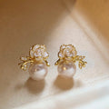 White Flower Pearl Drop Stud Earrings With Gold Tone Leaves view 6