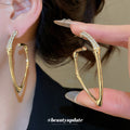 Gold Tone Angular Bamboo Hoop Earrings With Irregular Outline view 1