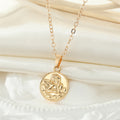 Gold Tone Embossed Cherub Coin Necklace and Huggie Earrings view 6