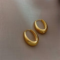 Gold Tone Smooth Chunky Oval Huggie Hoop Earrings Pair view 1
