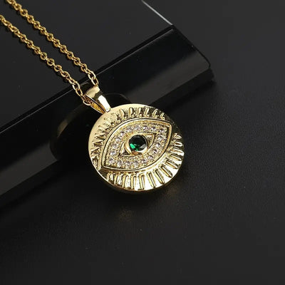 Product view showing a textured round gold-tone medallion with a green eye center