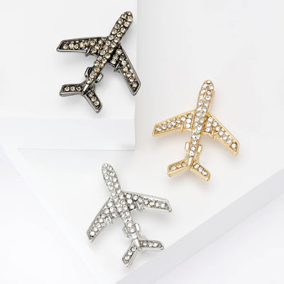 Front view of crystal airplane brooch in silver black and gold tone