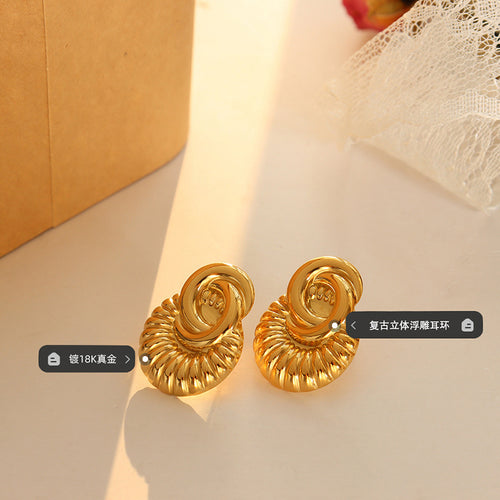Pair of gold shell fan studs flat lay with plating emboss labels