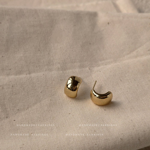 Gold-tone chunky curved huggie-hoop studs in the first product display.