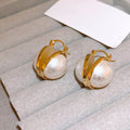 Large White Pearl Gold Tone Huggie Earrings With Metal Details view 4
