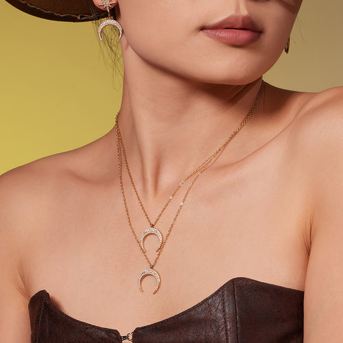 Neckline view of crystal crescent and starburst jewelry in main image 2.