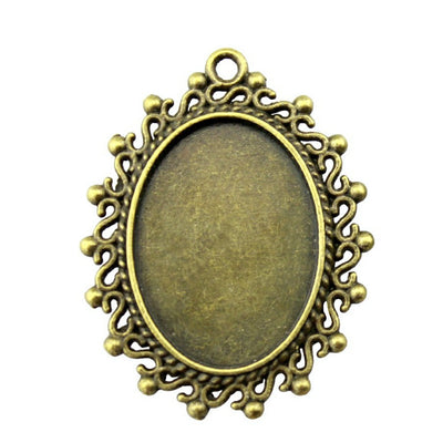 Scrolled Frame Oval Cabochon Pendant Trays in Two Finishes shown in image 1 with a curled ornamental border