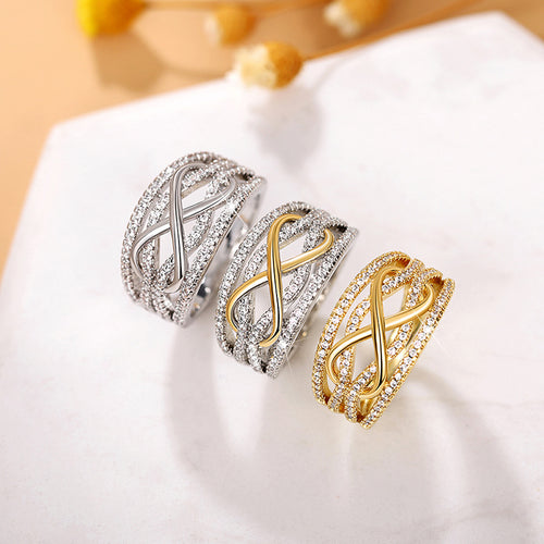 Three metal-tone versions of the wide infinity motif ring