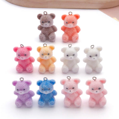 Multicolor bear jewelry findings arranged on a light background