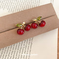 Glossy Red Cherry Stud Earrings With Green Leaf Accents view 4