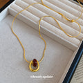Red Teardrop Gold Tone Necklace With Polished Metal Tone Details view 2