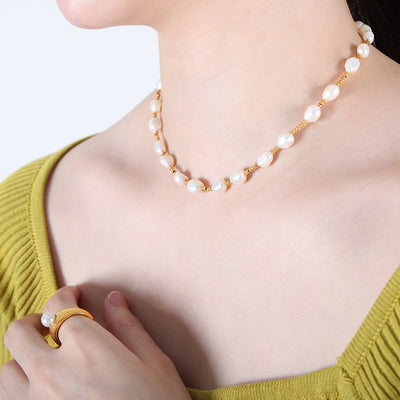 Model wearing baroque pearl and gold bead choker necklace