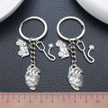 Two Silver Tone Ambulance Syringe and Heart Keychains view 3