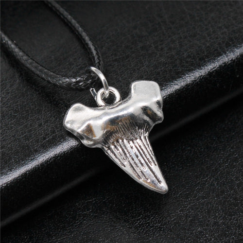 Alternate angle of shark tooth cord necklace showing a textured shark-tooth pendant on a black cord