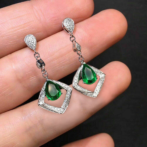 Front view showing green teardrops inside open geometric frames