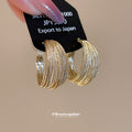 Gold Tone Layered Textured Multi Band Wide Hoop Earrings view 1