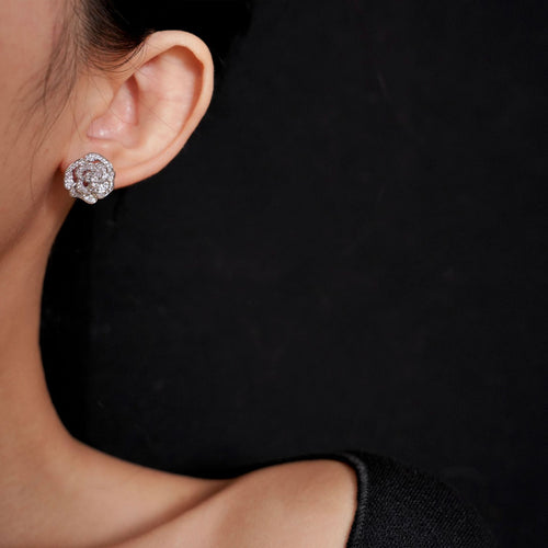 silver tone rose stud earrings displayed from a second angle